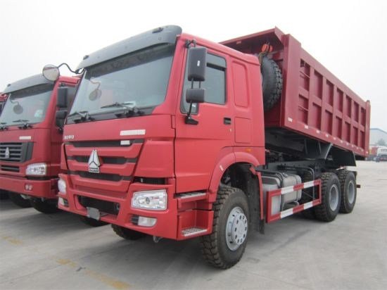 Red dump trucks used for road delivery to the project spot